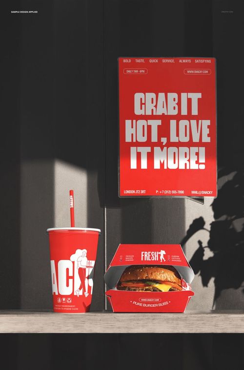 Front view of a burger box, drink cup, and red poster mockup arranged on a dark surface with strong sunlight.