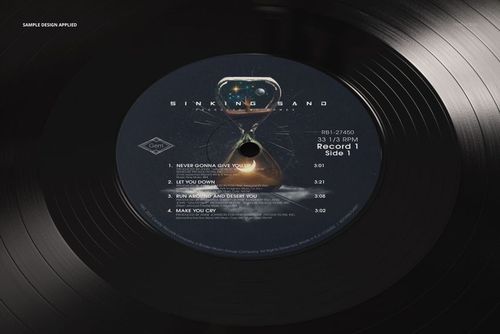 Mockup of a black vinyl record with a creative label artwork, seen in closeup with visible texture and light reflections.