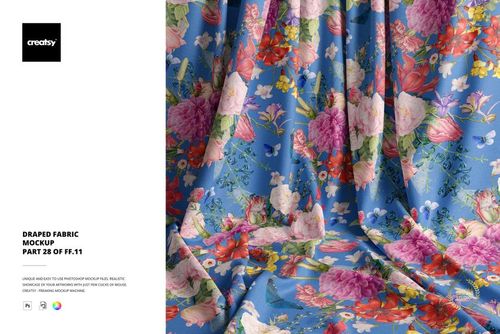 Front view of a draped fabric mockup with colorful flowers and green leaves on a blue surface, detailed texture visible.