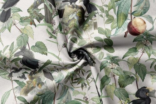 PSD mockup of upholstery fabric with a colorful botanical print, including birds and fruit, shown from above with a central fold.