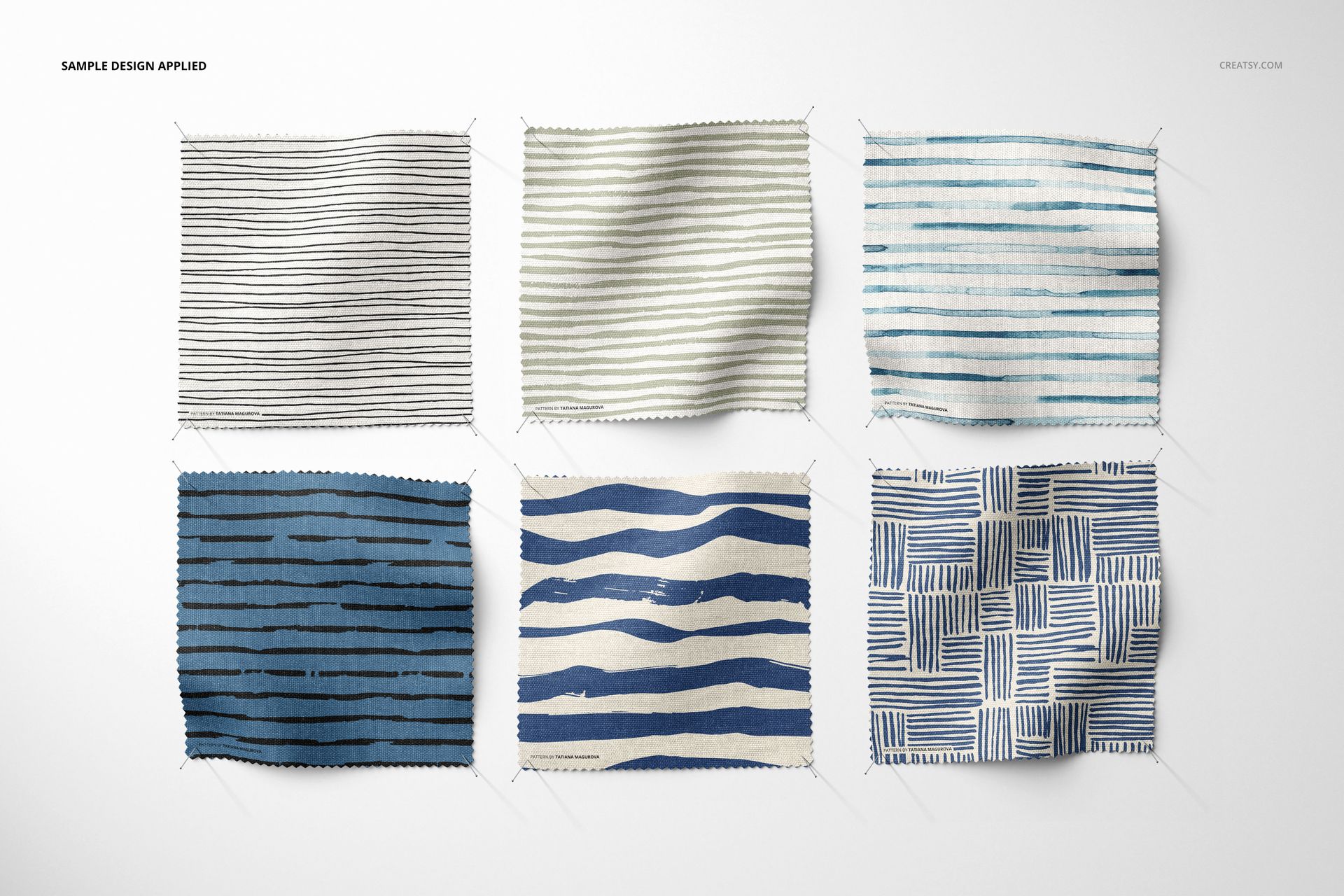 Fabric swatches mockup set displaying assorted blue and black patterns, each pinned at the corners against a plain backdrop.