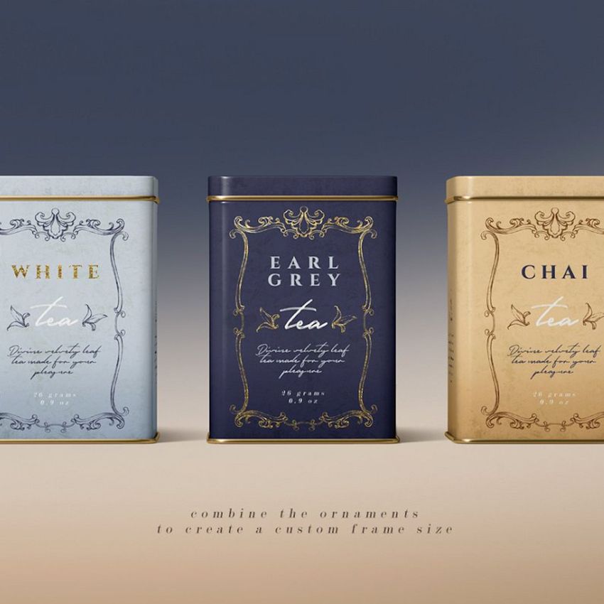 Three rectangular tin canisters in pastel blue, navy, and beige are displayed side by side, each with ornate gold detailing and centered text.