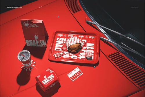 Burger, fries, and branded packaging set on a red car hood, top-down perspective with mockup tray and drink cup.