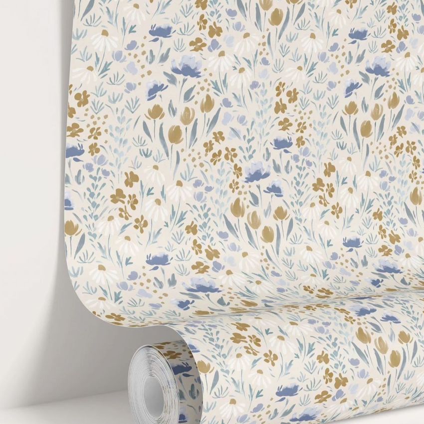Paper wallpaper mockup featuring a rolled sheet with a delicate floral pattern in blue, gold, and white on a light background.