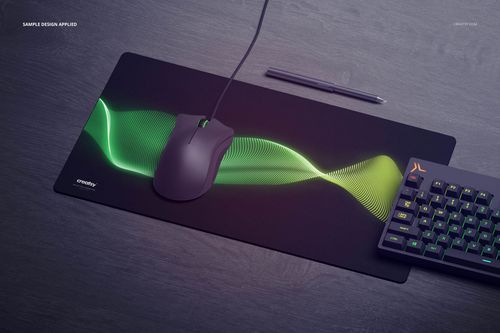 Rectangular gaming mouse pad mockup with green wave pattern, shown in top view on a dark desk with keyboard and pen.