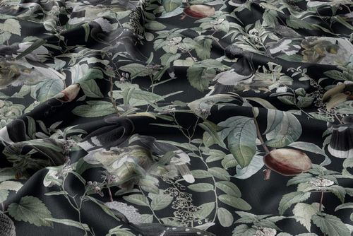 Tablecloth fabric mockup featuring a dark background with botanical and bird illustrations, shown in a draped perspective.