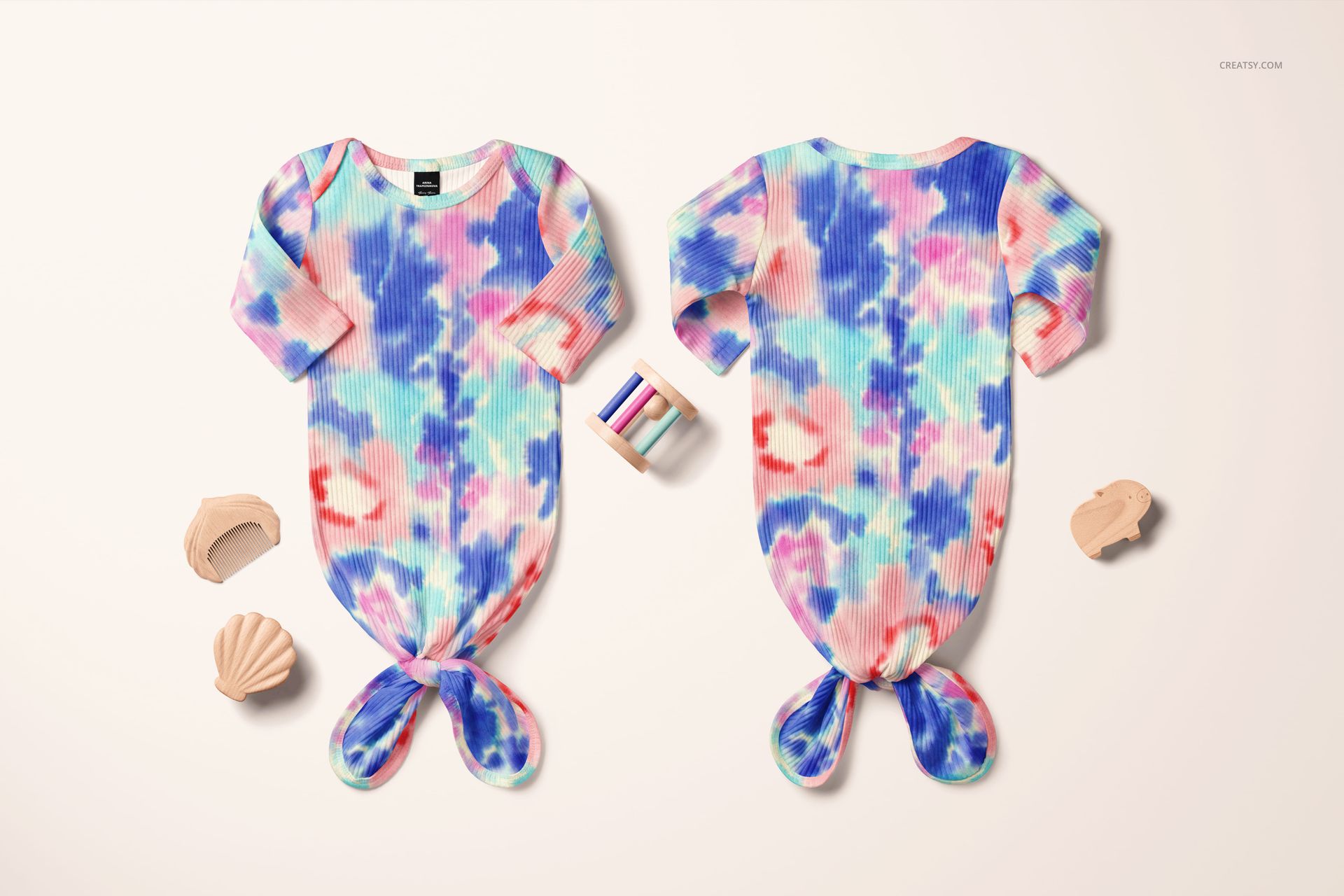 PSD mockup featuring a pair of ribbed baby gowns with knotted ends, vivid multicolor design, and playful accessories.