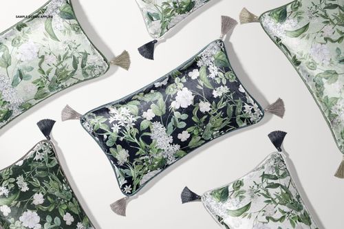 PSD mockup of rectangular cushions with tassels, decorated with leafy floral prints, viewed from above in a home setting.