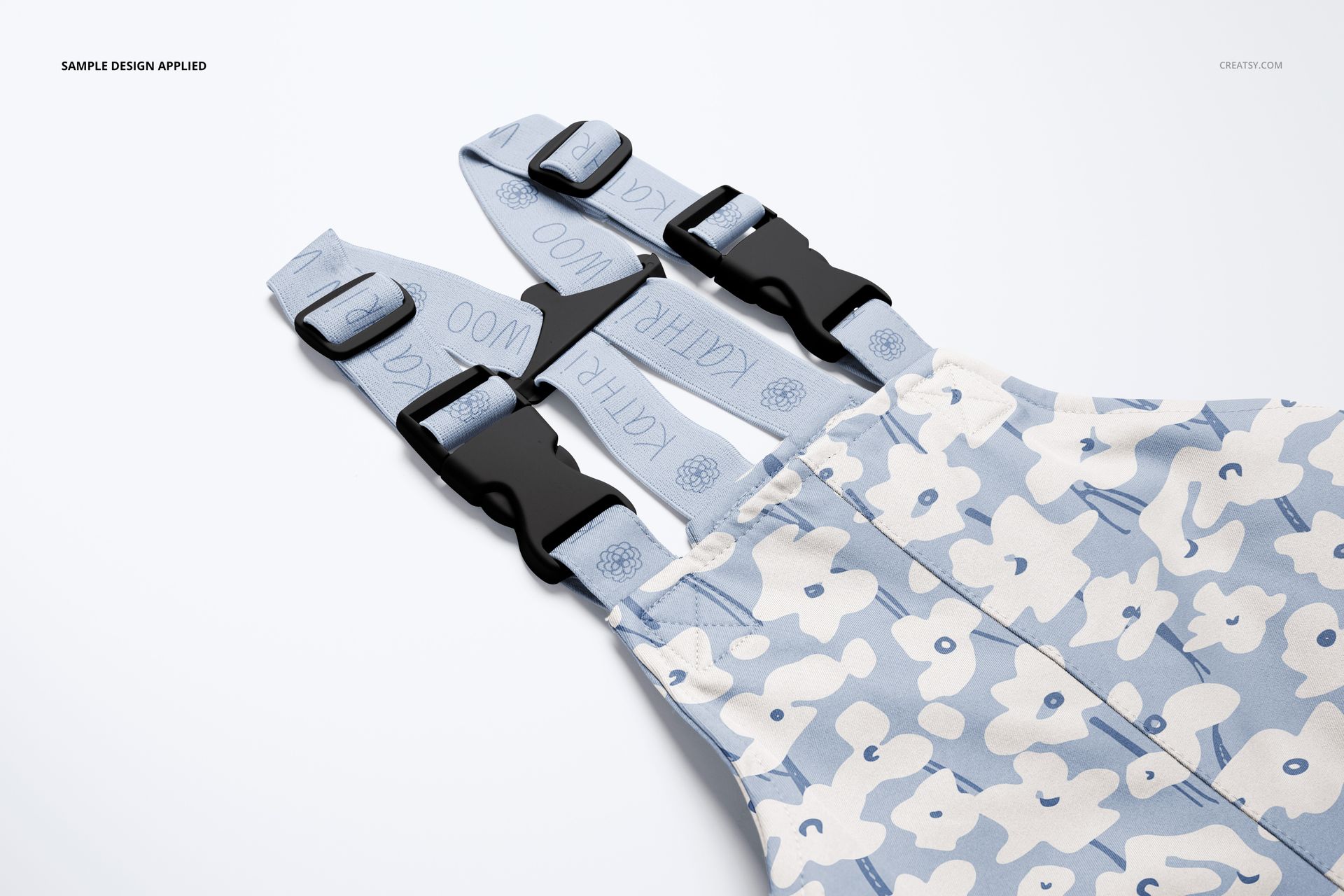Front view of kids rainwear mockup with adjustable straps, light blue floral pattern, and black buckles.