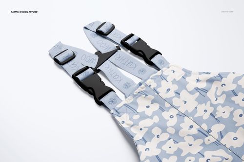 Front view of kids rainwear mockup with adjustable straps, light blue floral pattern, and black buckles.