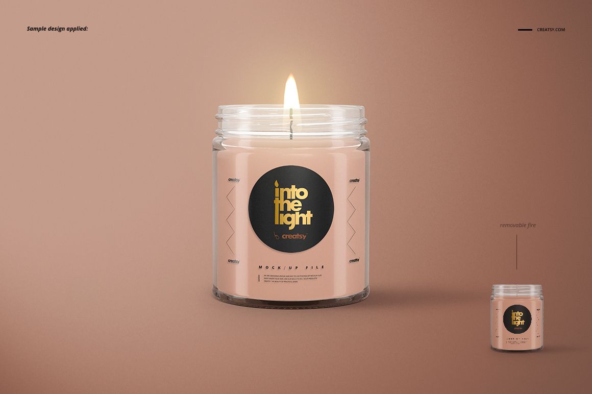 PSD mockup of a glass jar candle featuring a burning wick, beige wax, and dark round label, set against a brown backdrop.