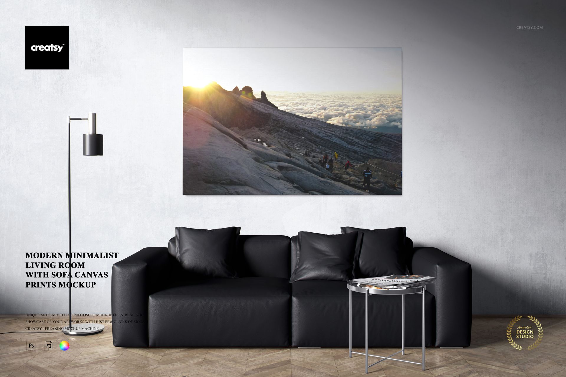 PSD mockup showing a spacious living room with monochrome decor, black sofa, and a framed canvas print on the wall.