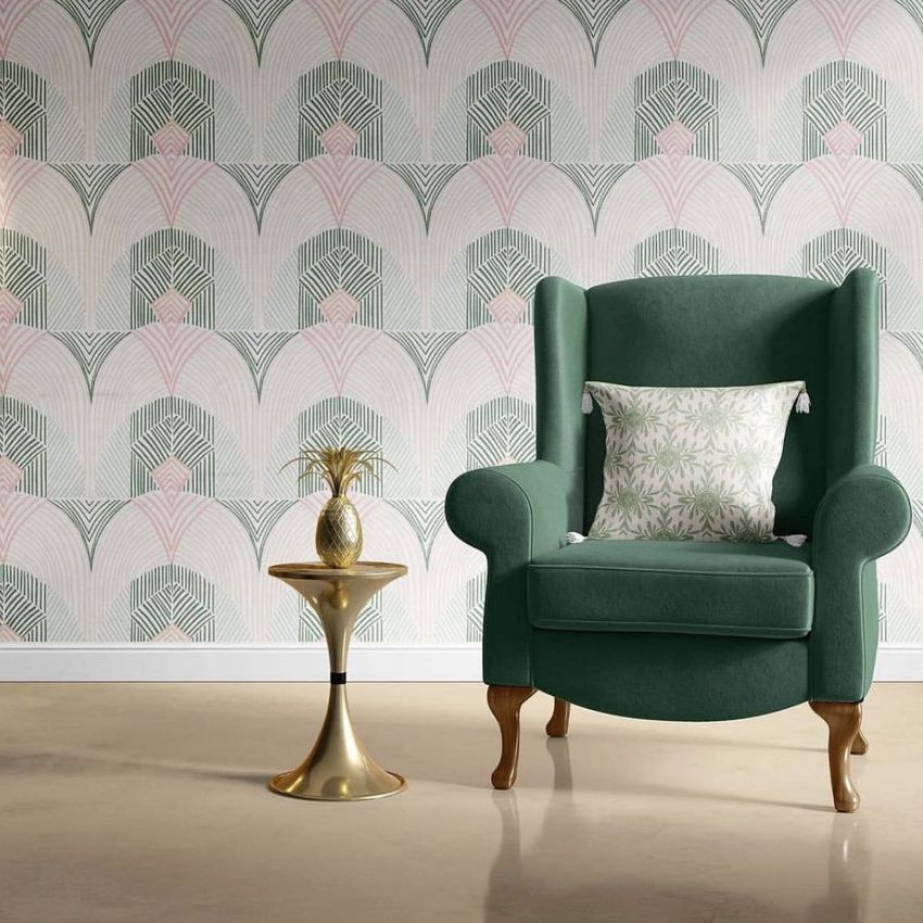 Retro velvet armchair mockup scene featuring a green armchair with a patterned cushion beside a small gold side table.