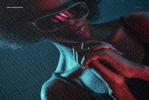 Close-up view of a canvas paper mockup featuring a woman with sunglasses, illuminated by blue and red lighting.