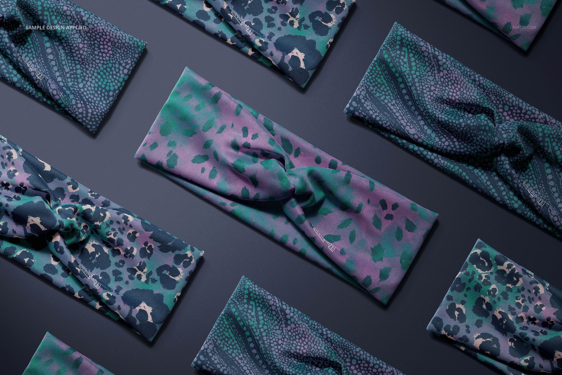 Faux knot headbands with abstract green and purple patterns arranged on a dark surface, top view mockup.