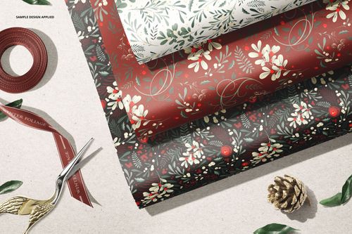 Botanical-themed wrapping paper mockup set featuring white, red, and black sheets in a layered front view scene.
