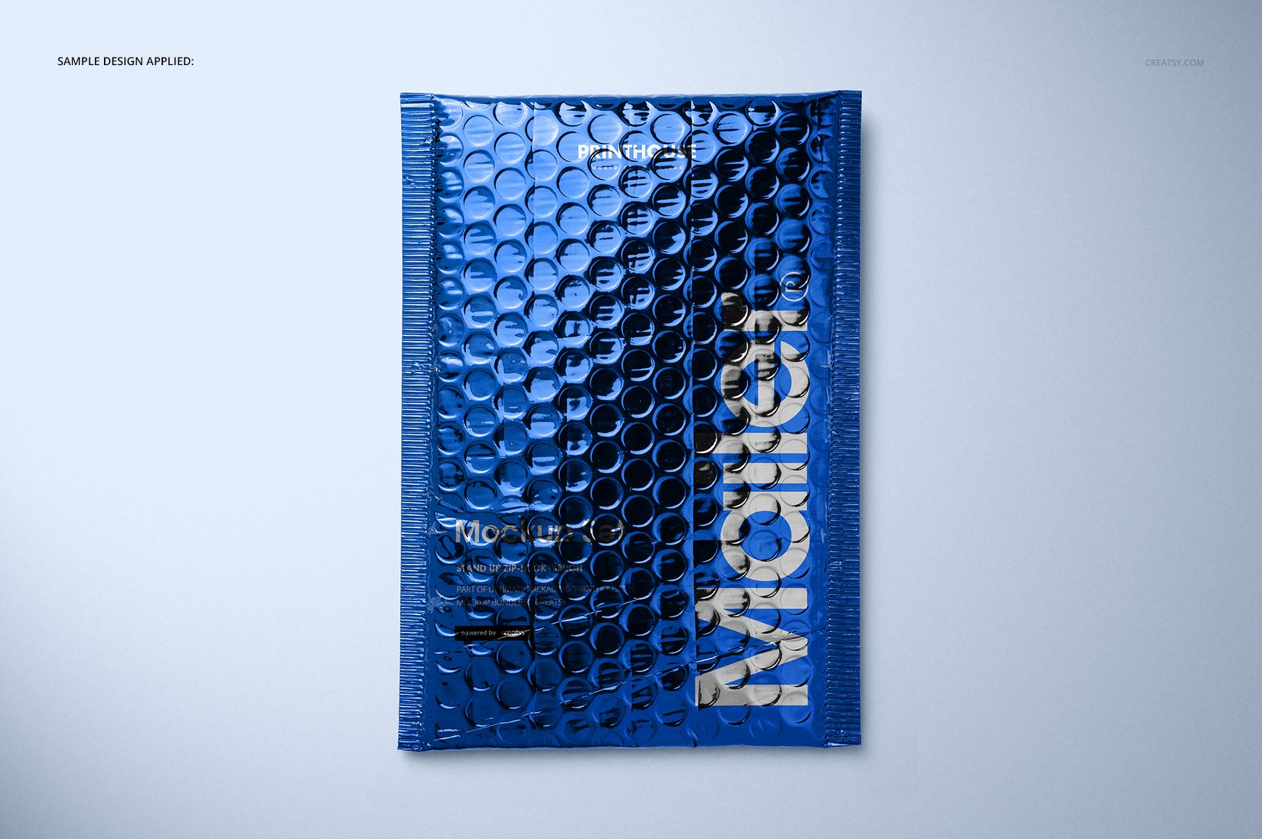 Top view of a blue metallic bubble mailer mockup with embossed bubble texture and bold silver lettering.