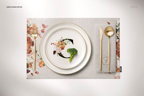 PSD mockup showing a dining scene with a light fabric placemat, napkin, decorative plate, and gold fork, knife, and spoon.