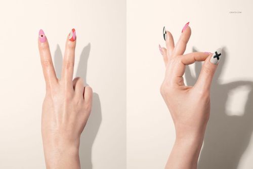 Two hands with manicured nails featuring colorful geometric designs, shown against a light background in a front view.