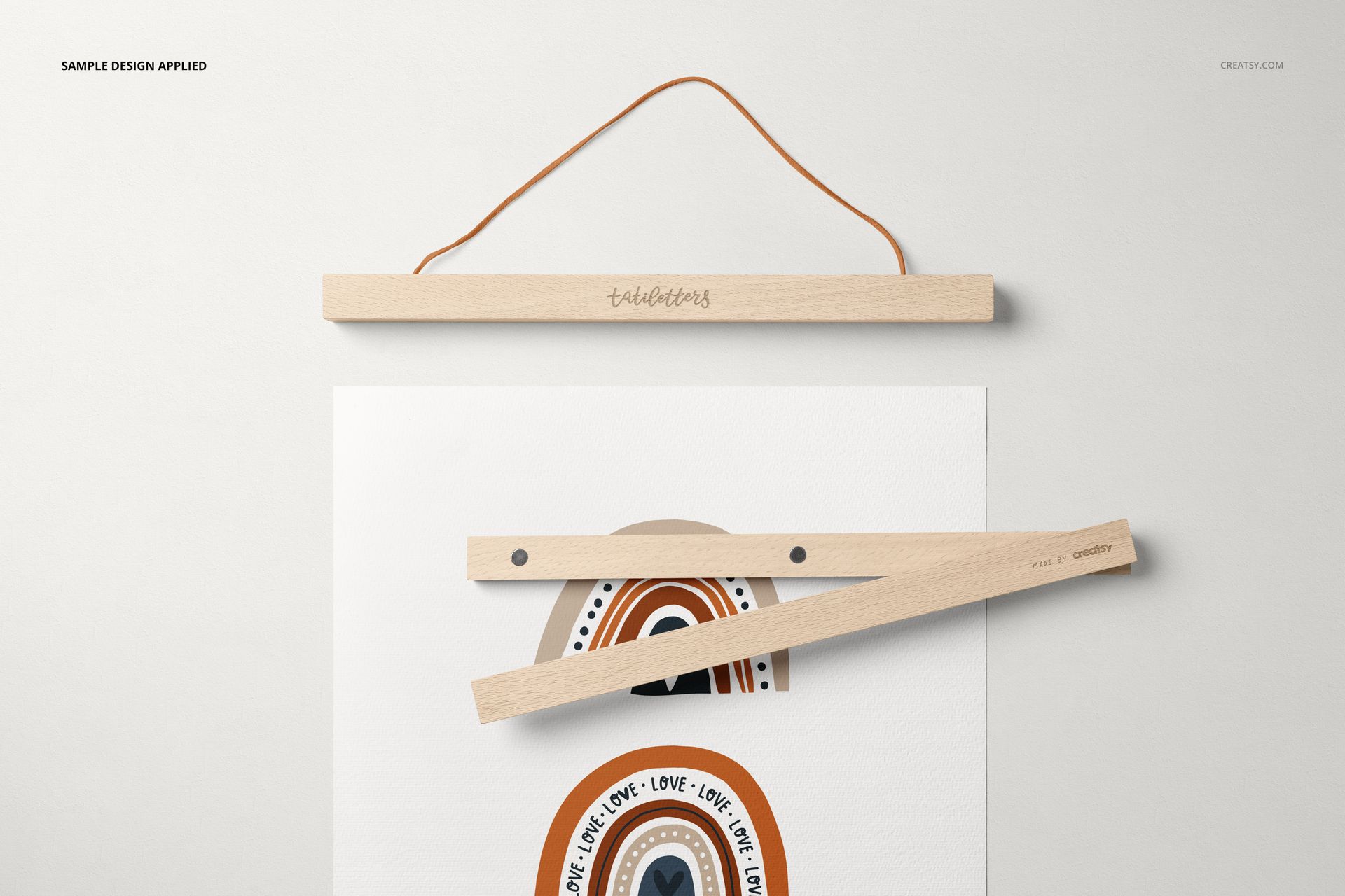 Wooden poster hanger mockup showing an A3 print with geometric rainbow artwork, viewed from above on a white surface.