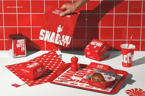 Burger packaging set mockup featuring red branded boxes, wrappers, cup, and tray on a countertop with tiled background.