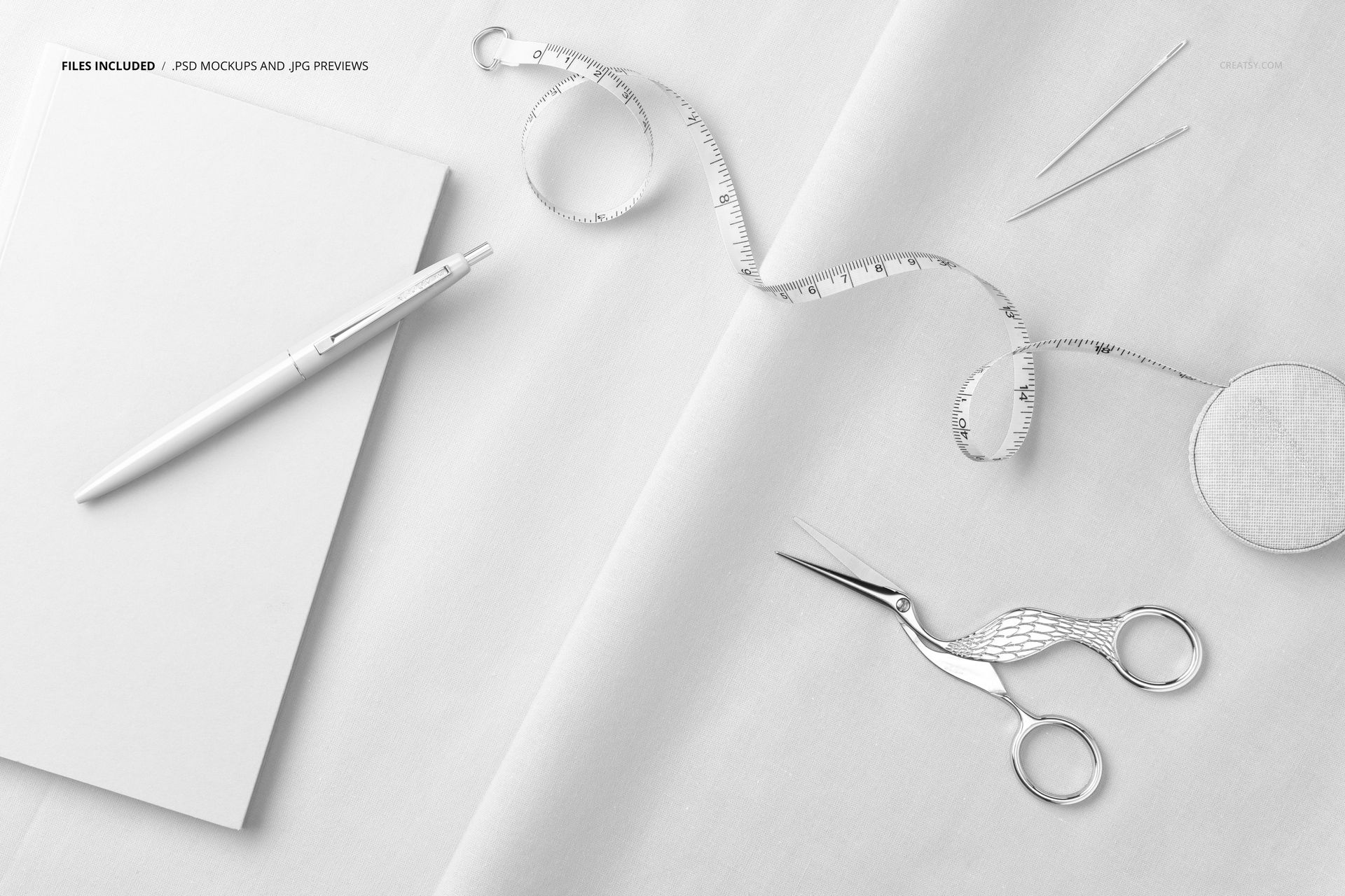 Cotton fabric mockup featuring a notebook, pen, tape measure, scissors, and sewing tools arranged overhead.