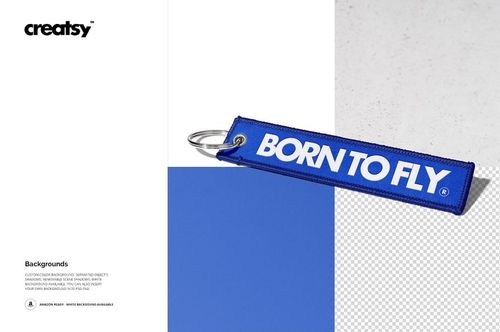 Mockup of a blue fabric keychain featuring white text, presented on a textured and color-blocked background.