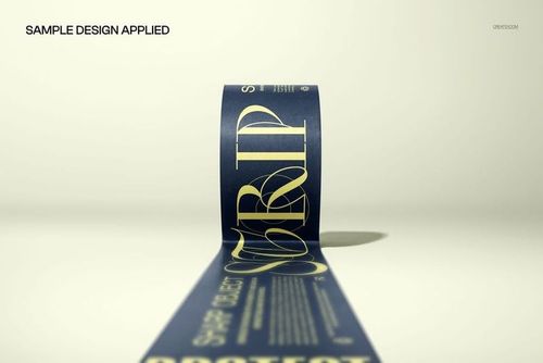 Wide tape mockup unrolled on a flat surface, viewed from a low angle with navy blue and gold printed design.