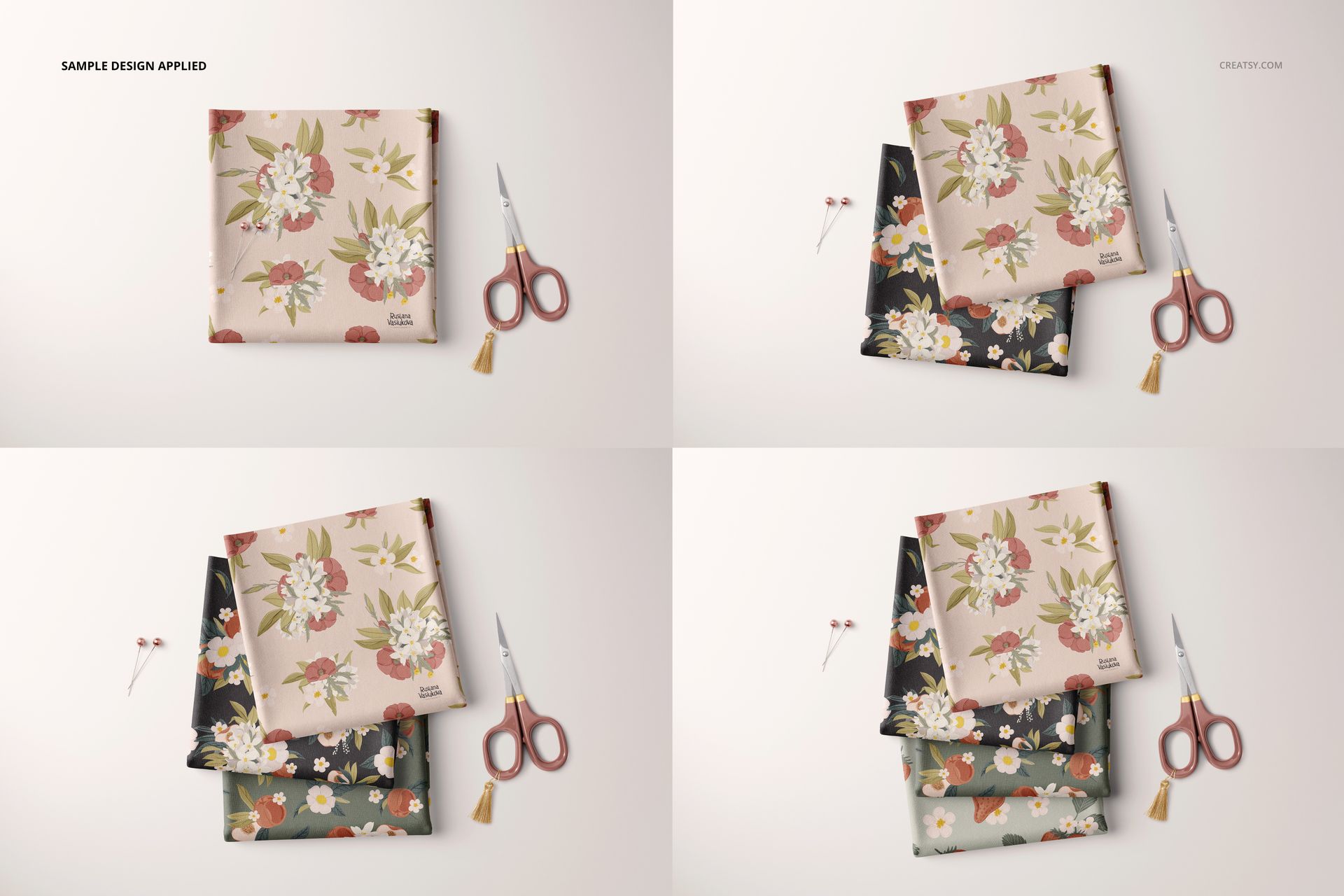 PSD mockup showing folded floral fabric samples in various colorways, placed beside scissors and sewing pins on a neutral background.