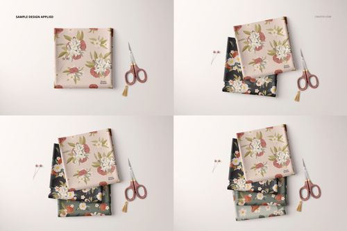 PSD mockup showing folded floral fabric samples in various colorways, placed beside scissors and sewing pins on a neutral background.