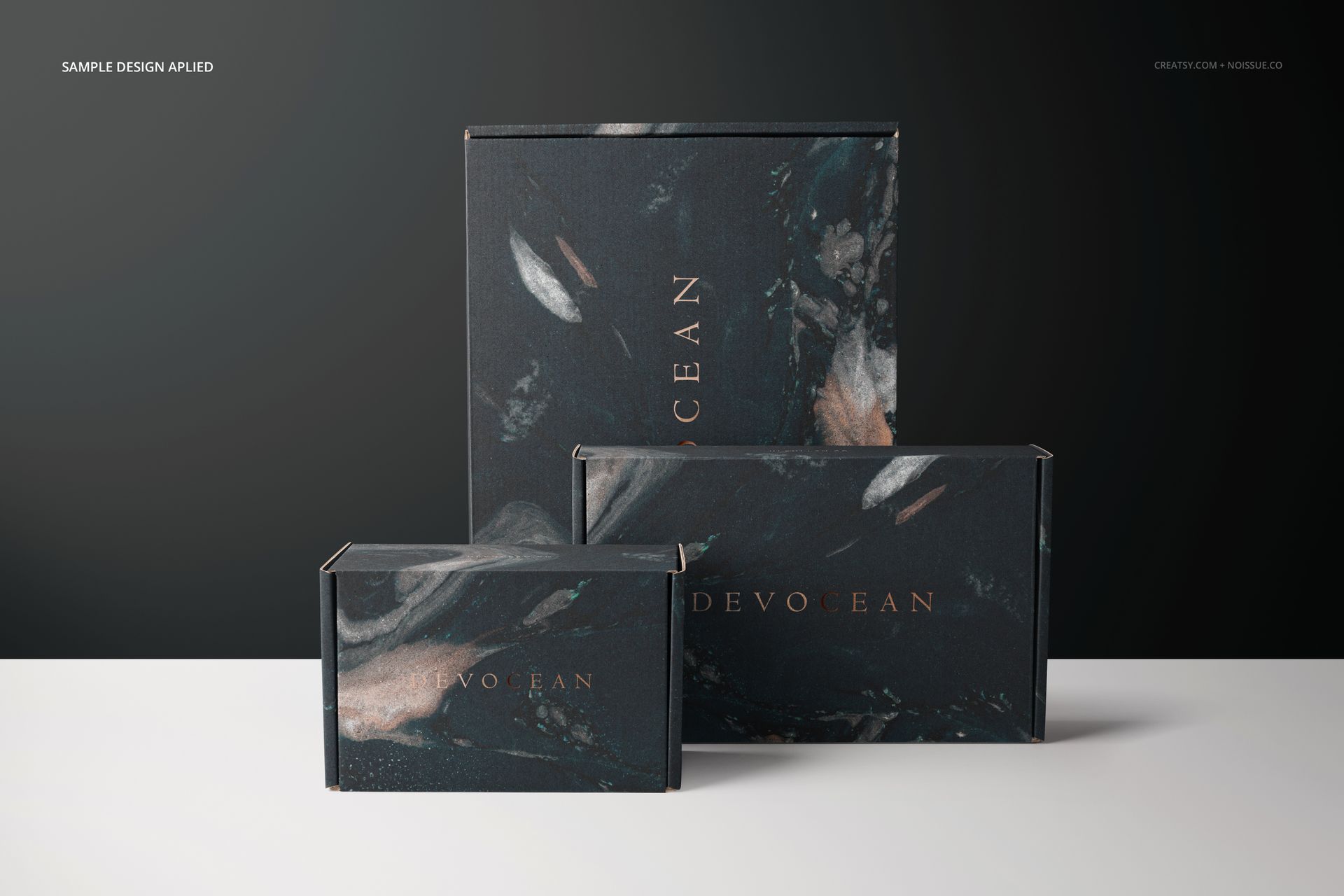PSD mockup of mailing boxes in various sizes, decorated with a dark swirling pattern and metallic highlights.