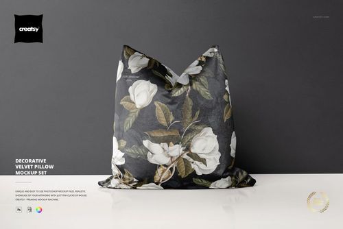 Decorative velvet pillow mockup featuring large white flowers and green foliage, displayed upright against a neutral wall.