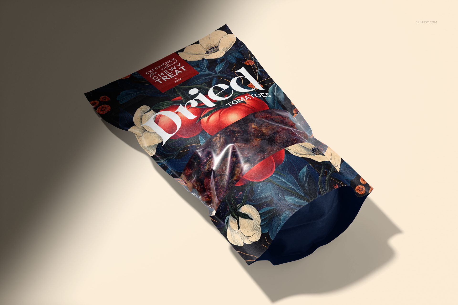 Paper pouch mockup featuring sun-dried tomatoes, dark floral graphics, and a clear window strip on a neutral surface.