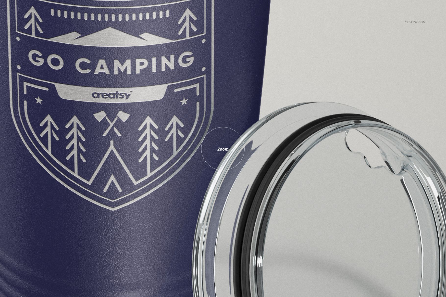 Close-up front view of a navy blue stainless steel tumbler with camping-themed white design and clear plastic lid beside it.