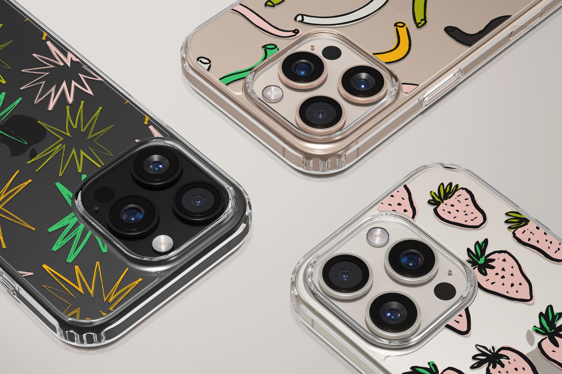 PSD mockup featuring three clear phone cases for iPhone, each with distinct fruit and plant designs, top perspective.