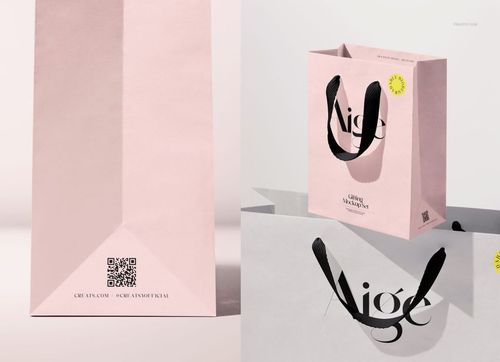 PSD mockup of two paper gift bags featuring cotton ribbon handles, minimalist background, and subtle shadows.