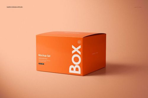Orange chipboard gift box mockup set shown from an angled perspective against a soft peach surface.