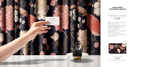 Fabric mockup featuring navy blue curtains with pink flowers and birds, shown with a hand holding a white card in foreground.