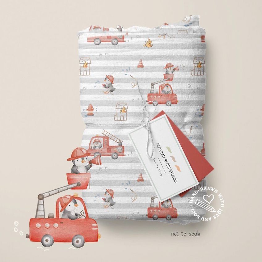 Muslin swaddle blanket mockup featuring a whimsical pattern of penguin firefighters, fire trucks, and cones on a striped background.