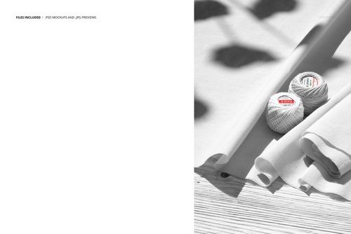 PSD mockup featuring white cotton textiles and crochet thread balls placed on a wooden background, viewed from the top.