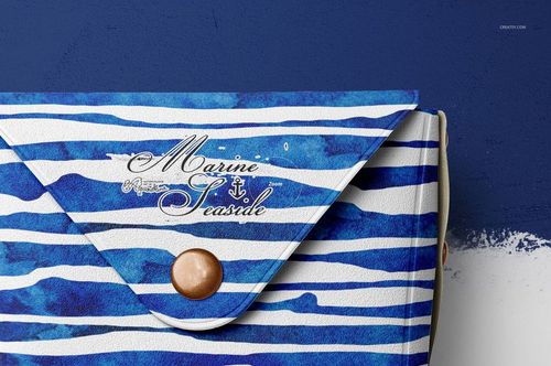 Close-up of a leather pouch wallet mockup featuring blue watercolor stripes, metallic button, and decorative text.