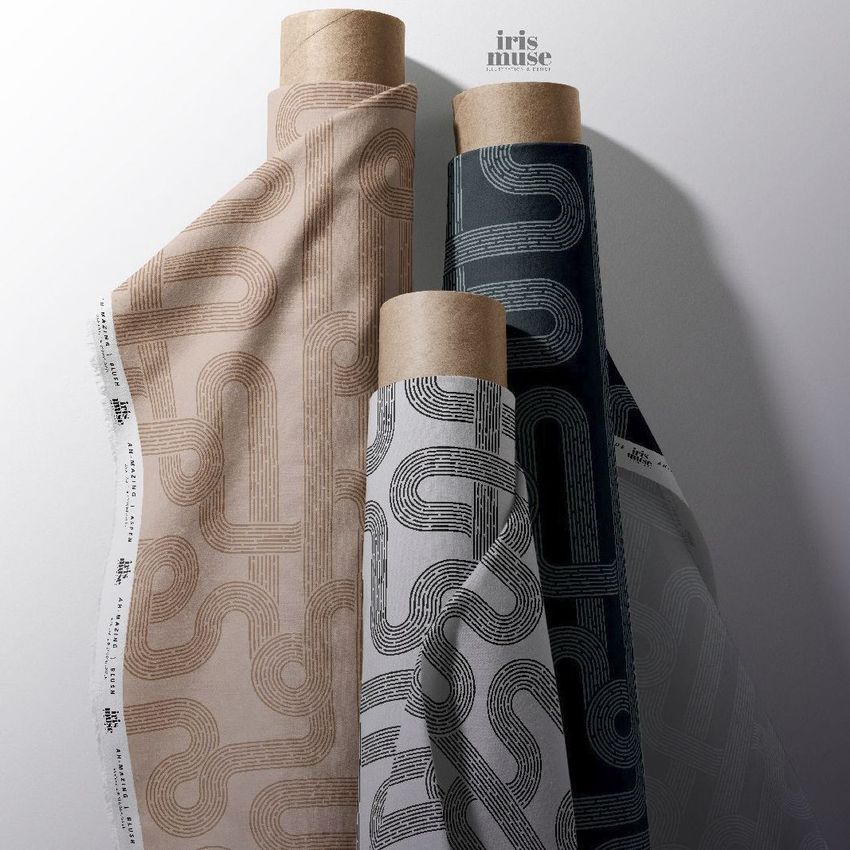 Customizable fabric rolls mockup showing three upright fabric rolls with geometric line patterns in beige, black, and white tones.