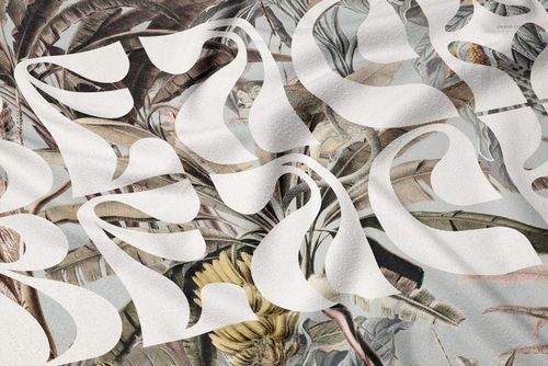 Fringed beach towel mockup with abstract white lettering over a botanical pattern, shown in a close-up view.