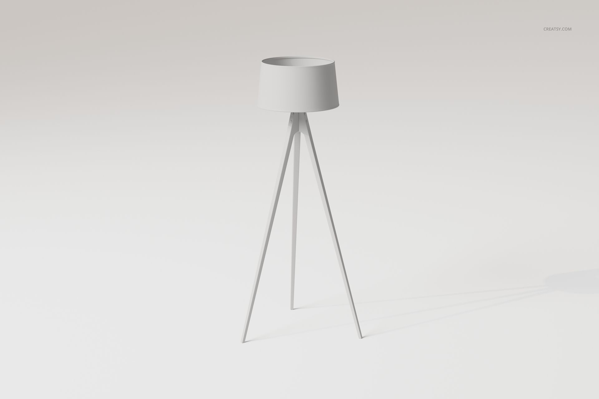 Minimalist tripod floor lamp with a cylindrical shade, shown from a front angle on a plain light background.