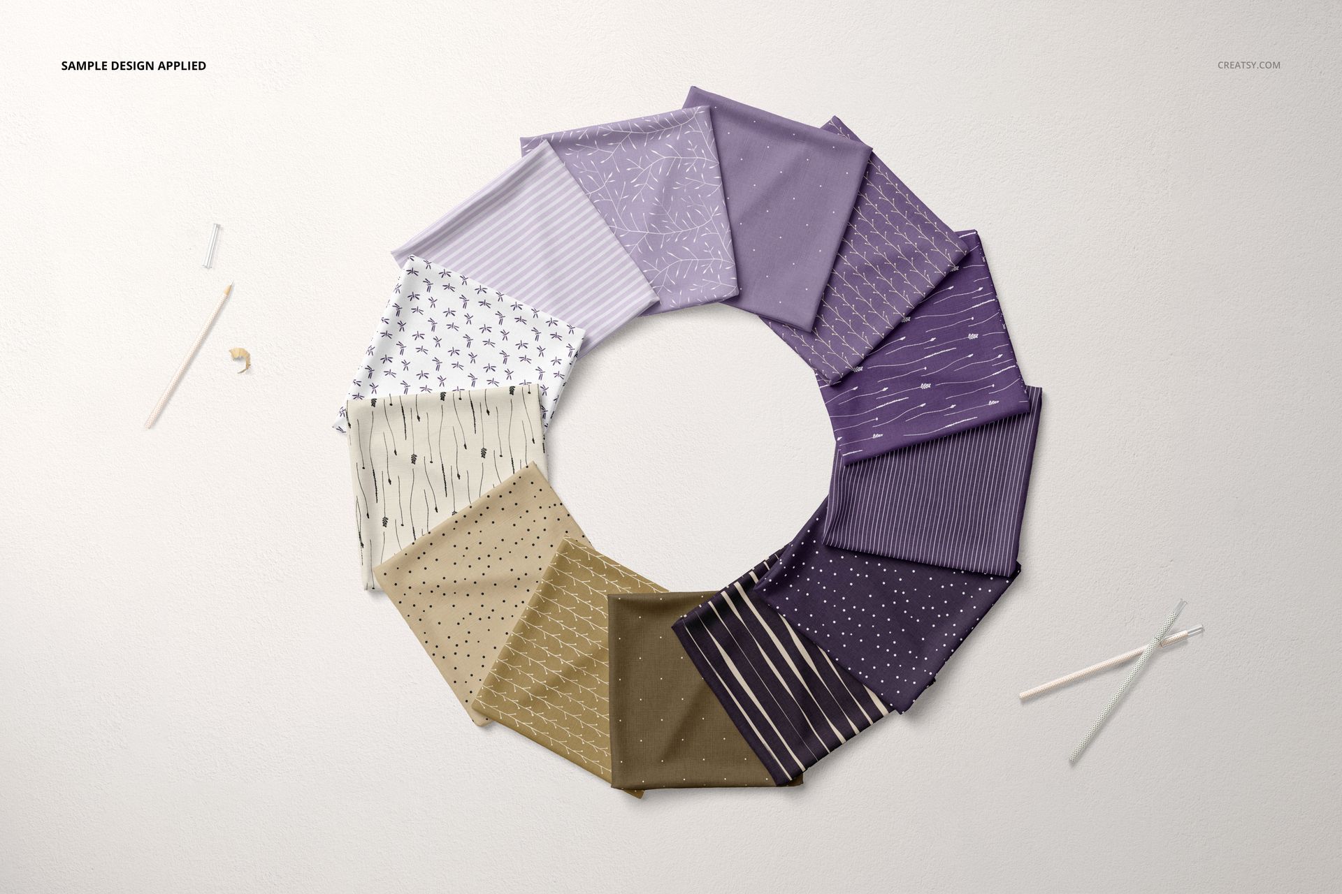 PSD mockup showing multiple folded fabric samples in a circular layout, highlighting assorted colors and prints.
