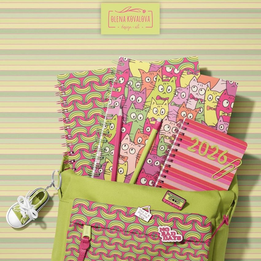 School backpack mockup with spiral notebooks featuring colorful cat illustrations and bold patterns, set against a striped background.