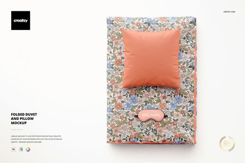 PSD mockup showing a folded duvet with multicolored floral design and a matching solid peach pillow, arranged flat.
