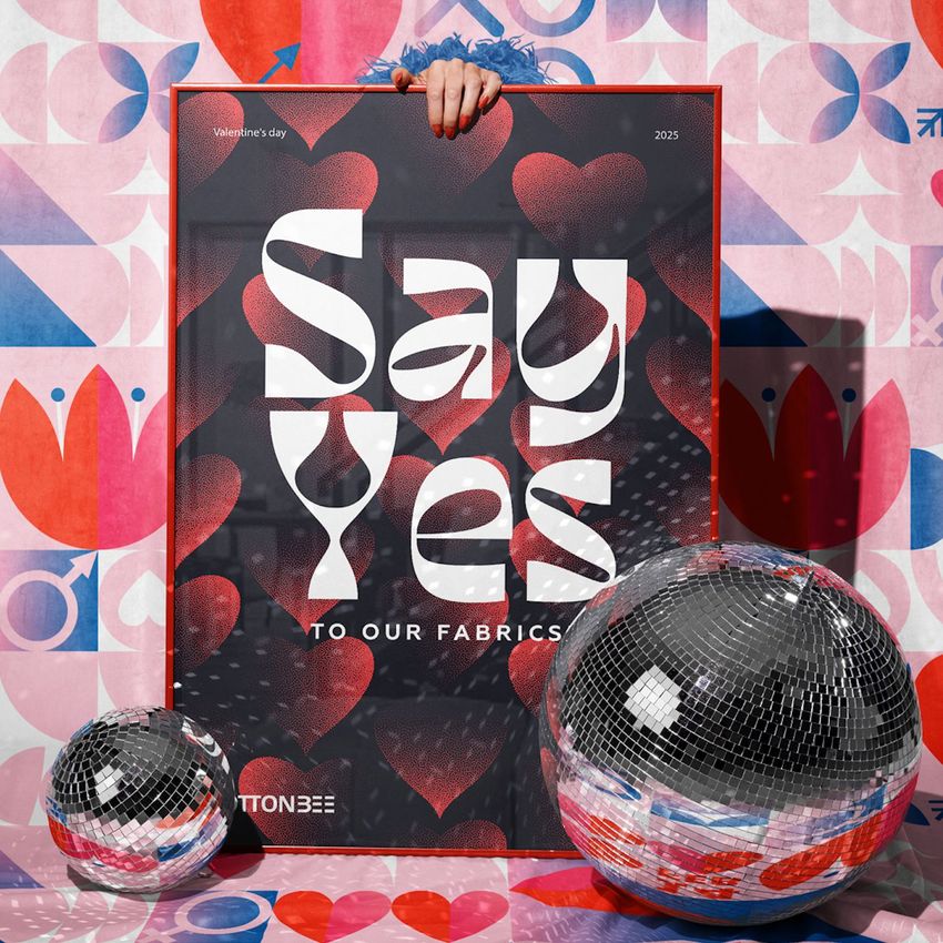 Poster mockup in a picture frame with bold white text and heart graphics, held by a hand against a colorful floral wall. Two disco balls are placed in front.