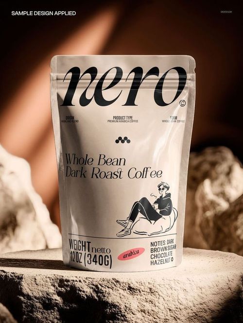 Front view of a shiny foil doypack mockup for coffee, placed among light-colored stone props under warm lighting.