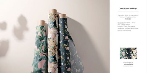 Side view of multiple patterned fabric rolls in various colors, shown in a studio setting for PSD mockup use.